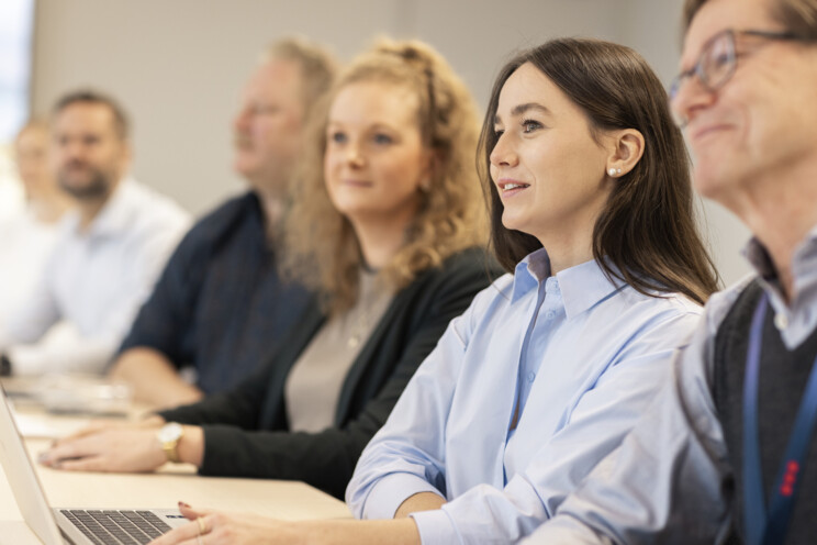Security professionals sitting in a meeting room together. 